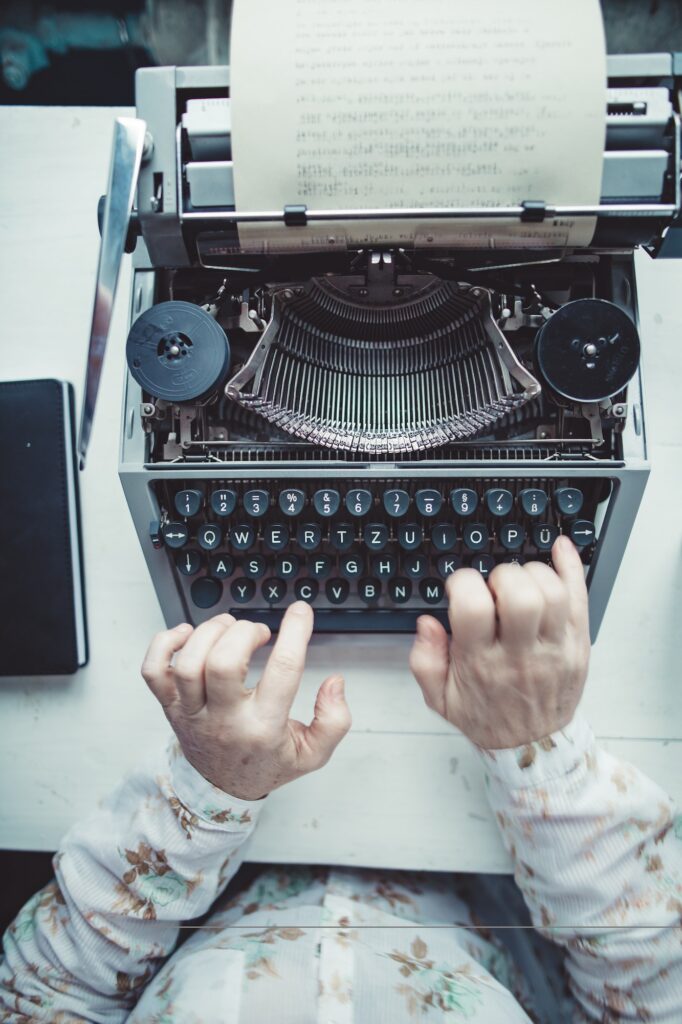 Writer typing with retro writing machine.
